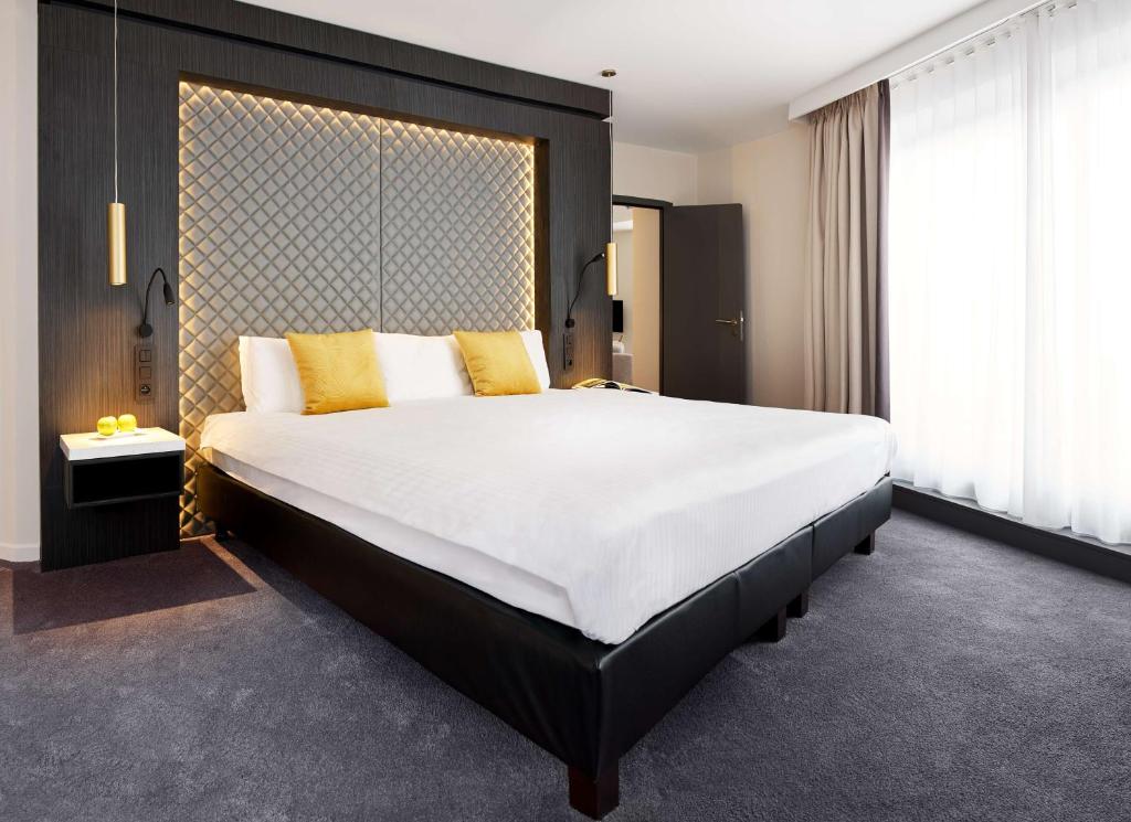 מיטה או מיטות בחדר ב-Van der Valk Hotel Spa