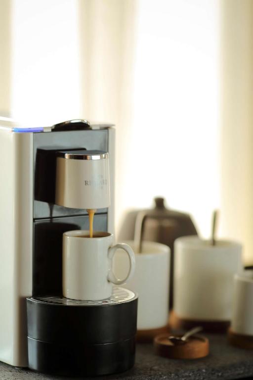 a group of coffee cups sitting on a counter at Radisson Blu Bali Uluwatu in Uluwatu