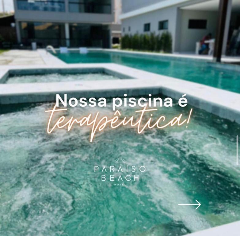 a pool of water with the words noosa piscina and temperature fertilized at Paraiso Beach Hotel in Aquiraz