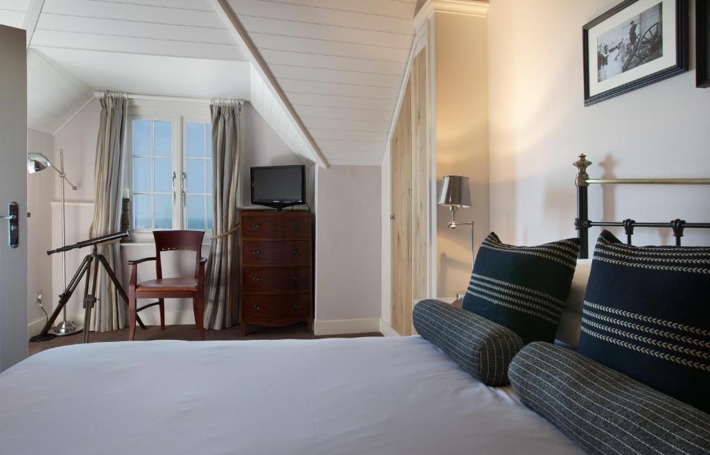 a hotel room with a bed and a television at The Marine in Whitstable