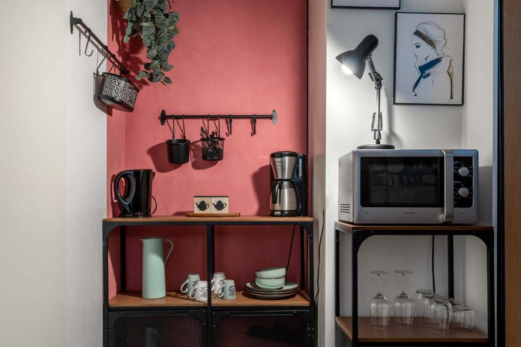 a room with two shelves with a microwave and a tv at Villa Eltins in Bad Bentheim