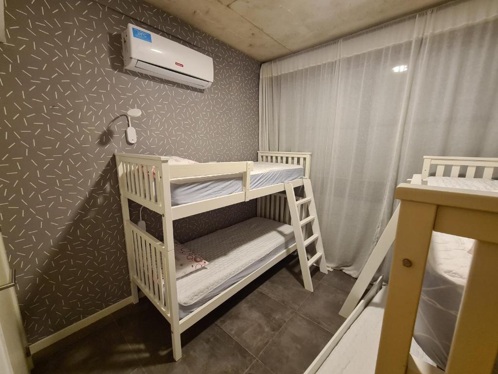 a small room with two bunk beds in it at Dpto The View, Puerto del Águila Lago Los Molinos in Potrero de Garay