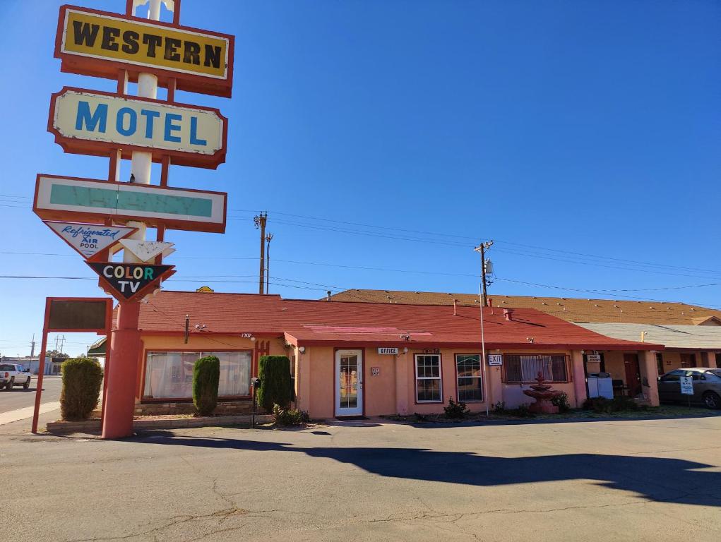 a motel with a sign in front of it at Western Motel in Deming