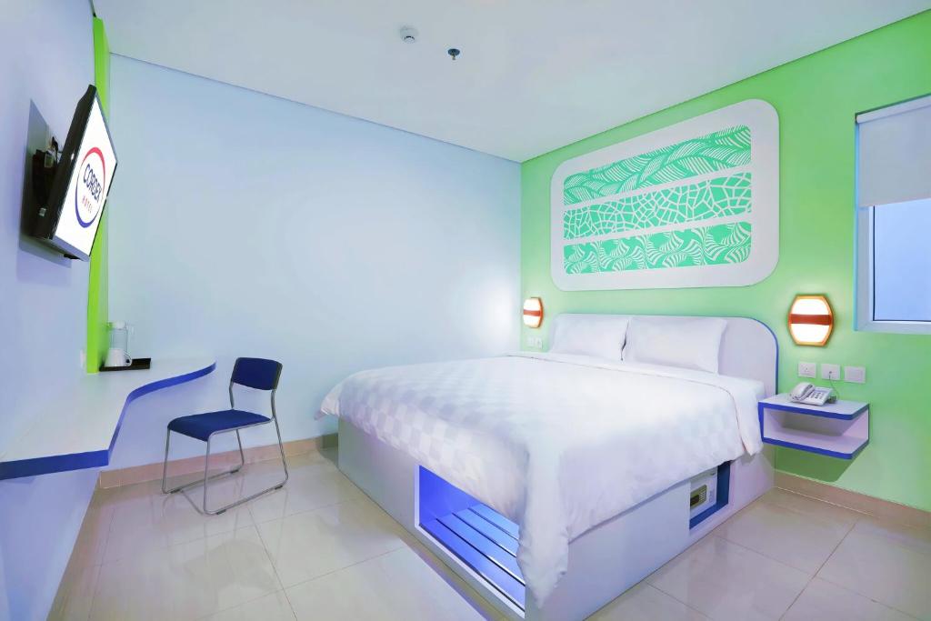 Postel nebo postele na pokoji v ubytování Cordex Hotel Ancol