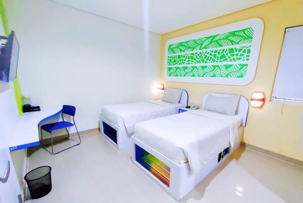 Postel nebo postele na pokoji v ubytování Cordex Hotel Ancol