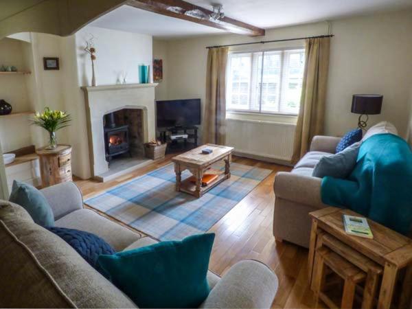 a living room with a couch and a fireplace at Ash House in Alton