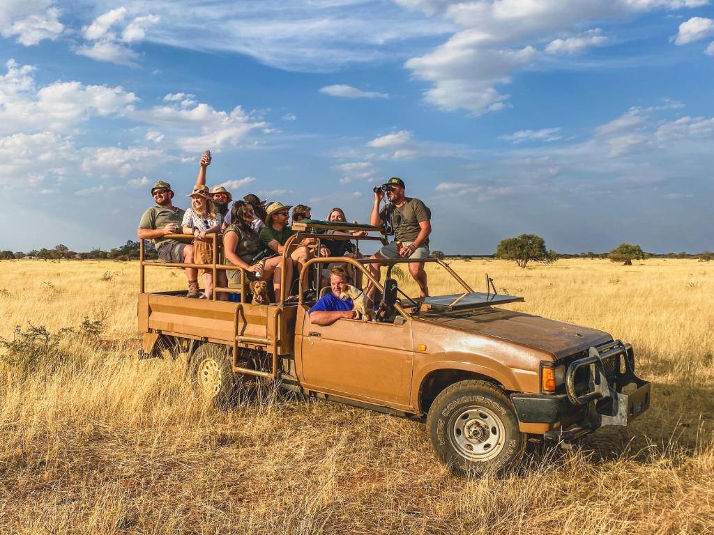 a group of people riding in the back of a truck at Ombe Guestfarm & Safari in Hochfeld