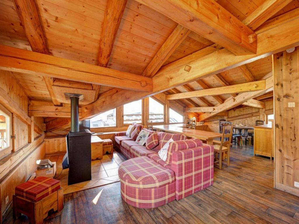 a living room with a couch and a stove in a cabin at Chalet La Plagne Montchavin Les Coches, 5 pièces, 13 personnes - FR-1-329-67 in La Plagne Tarentaise