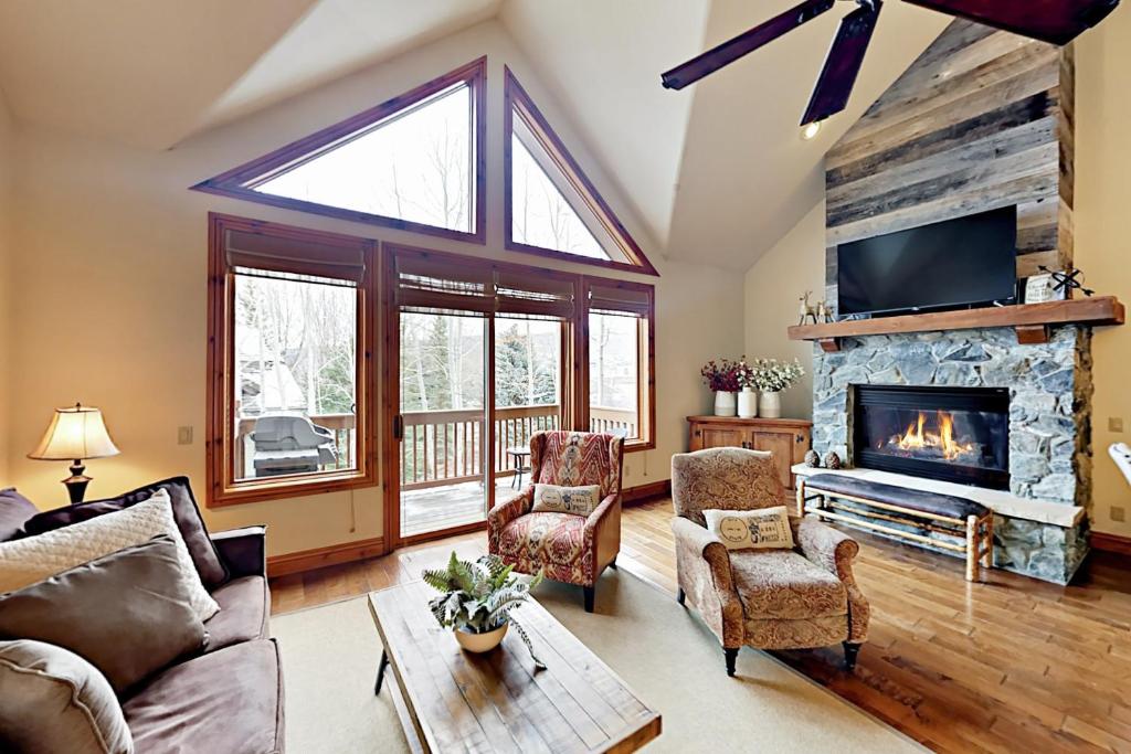 a living room with a fireplace and a tv at Sawatch Townhouse C8 in Edwards