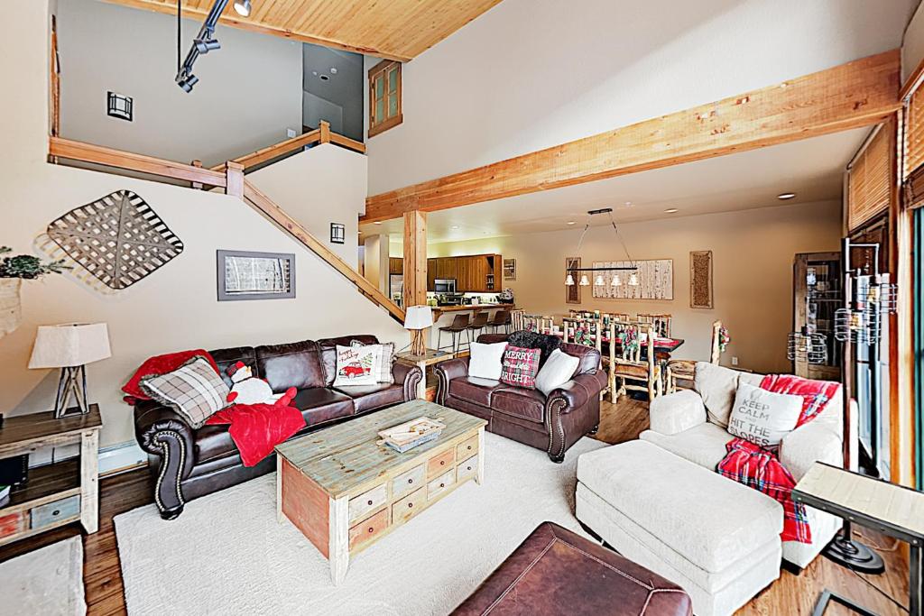 a living room with a couch and a table at Alpine Holidays Ski Tip in Keystone
