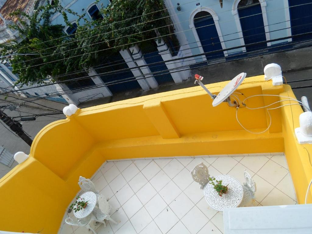 an overhead view of a yellow table with two chairs at Pousada Zumbi dos Palmares in Salvador