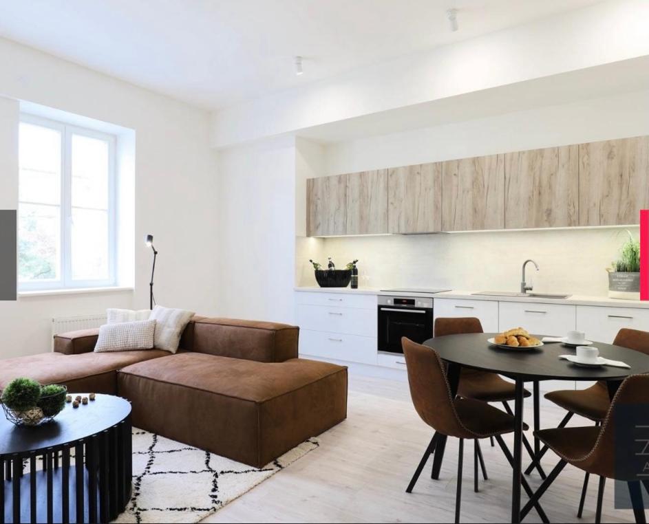 a living room with a couch and a table at Dagmar Apartment in Bratislava