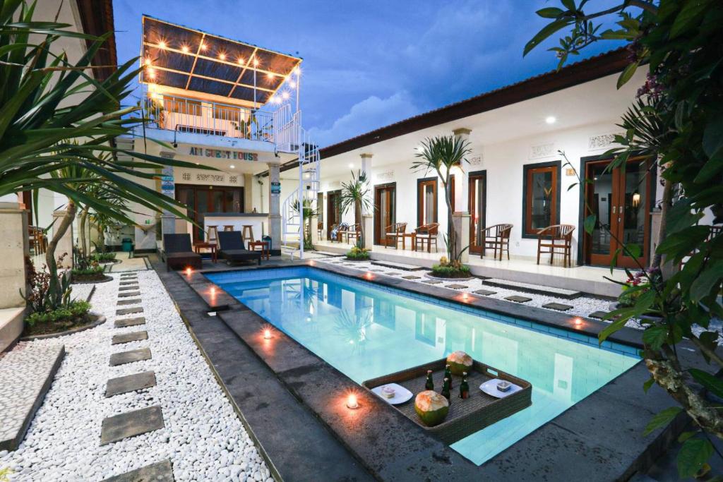 a swimming pool in the backyard of a house at Adi Guest House in Canggu
