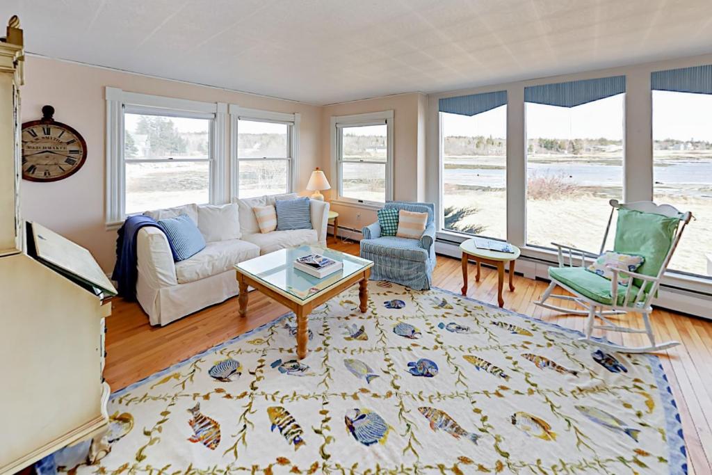 a living room with a couch and two chairs at Blue Flower in Prospect Harbor