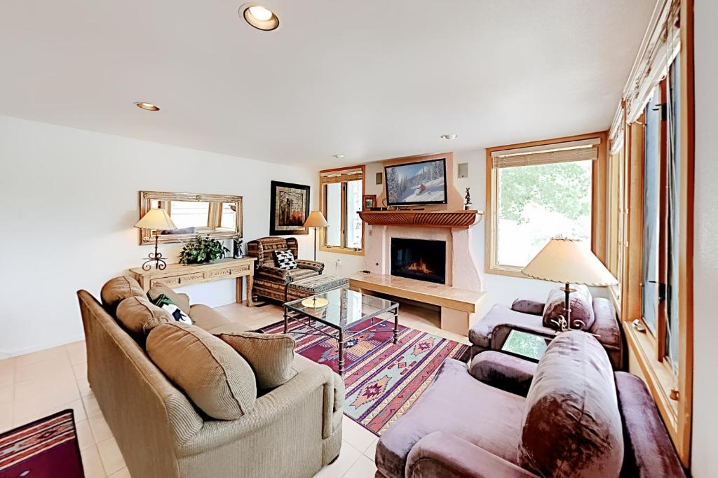 a living room with two couches and a fireplace at Tamarak 36 in Snowmass Village