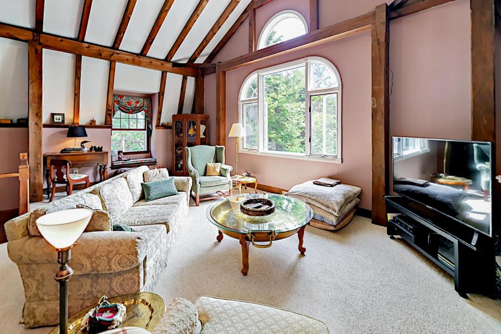 a living room with a couch and a table at Southport Island Cottage in Hendricks Harbor