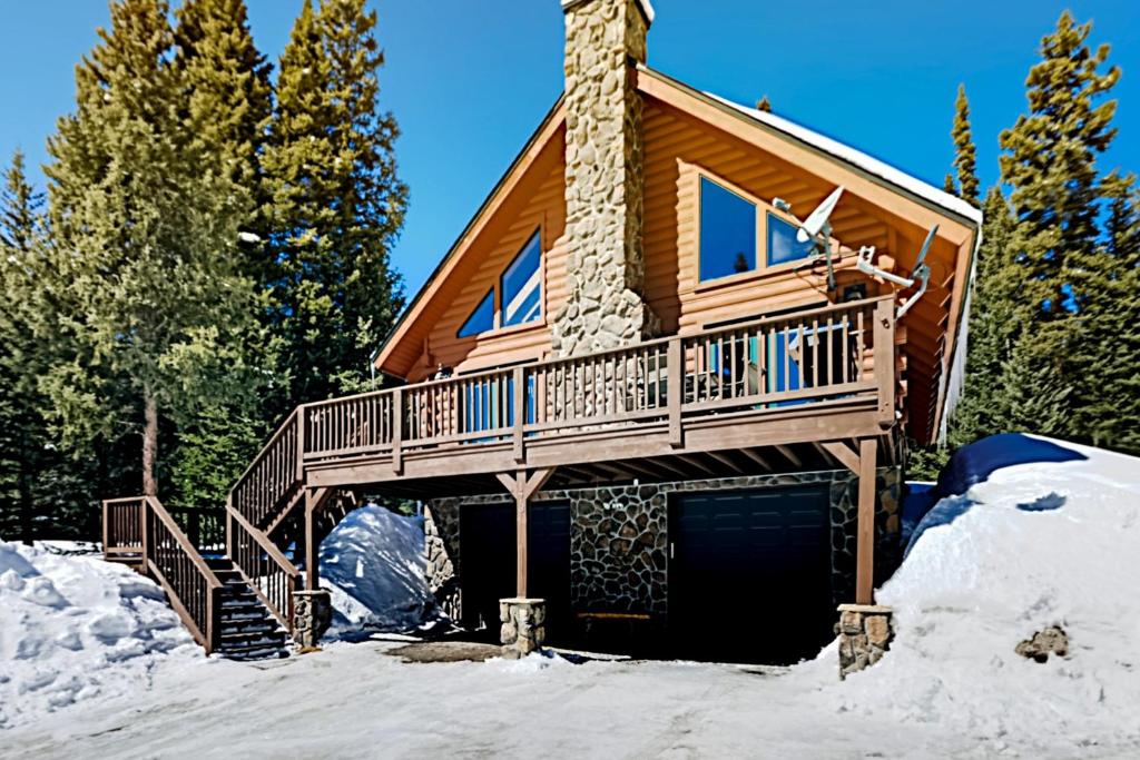 a log cabin in the snow with a garage at Little Bears Cabin in Breckenridge