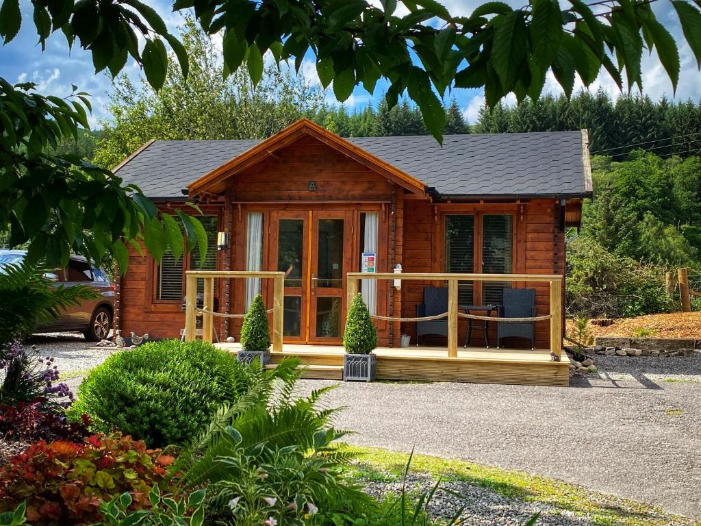 a small log cabin with a large window at Hill cottage cabins in Fort Augustus