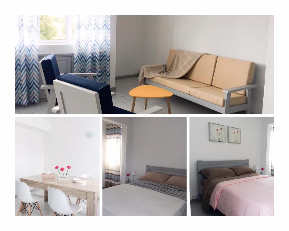 a room with a bed and a couch and a table at La Péninsule Town Apartment No 5 in Curepipe