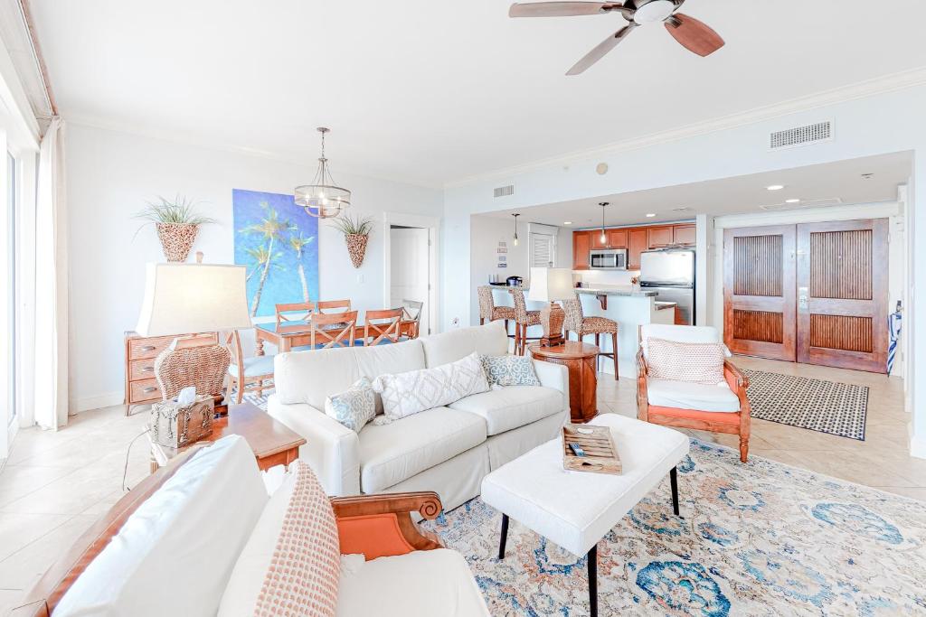 a living room with a white couch and a dining room at The Grand Sandestin II in Destin