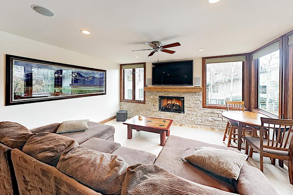 a living room with a couch and a fireplace at Tamarak 6 in Snowmass