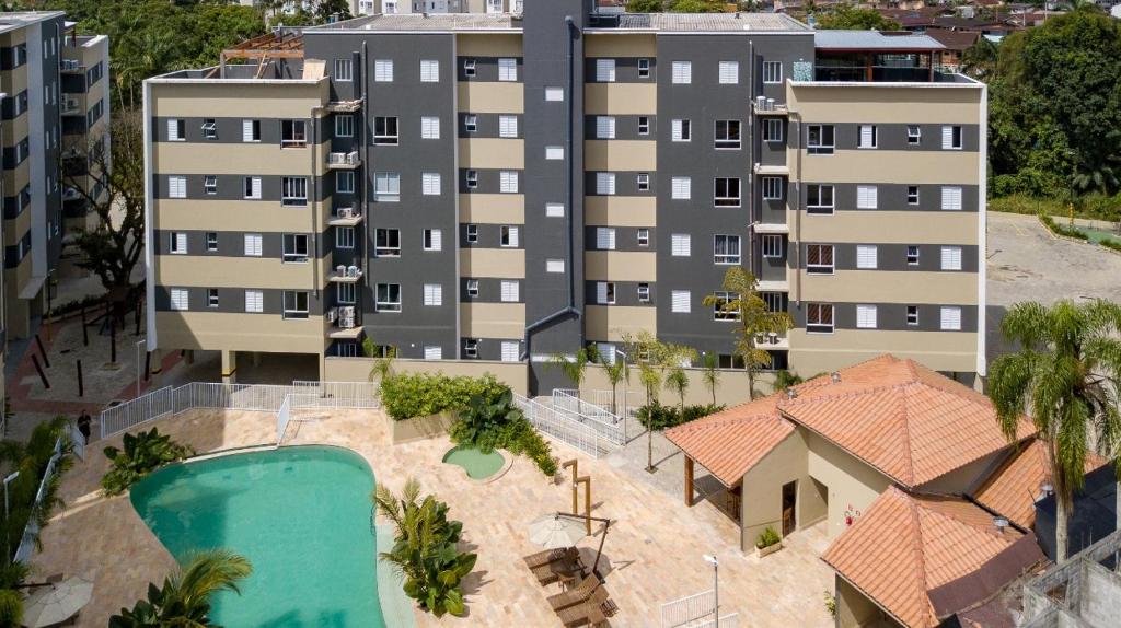 an aerial view of a building with a pool at Apto 2 Dorms, 1 Suíte, JP2 Home Resort Ubatuba - Churrasqueira Gourmet, Ar Condicionado, Piscinas, Sauna e Salão de Jogos in Ubatuba