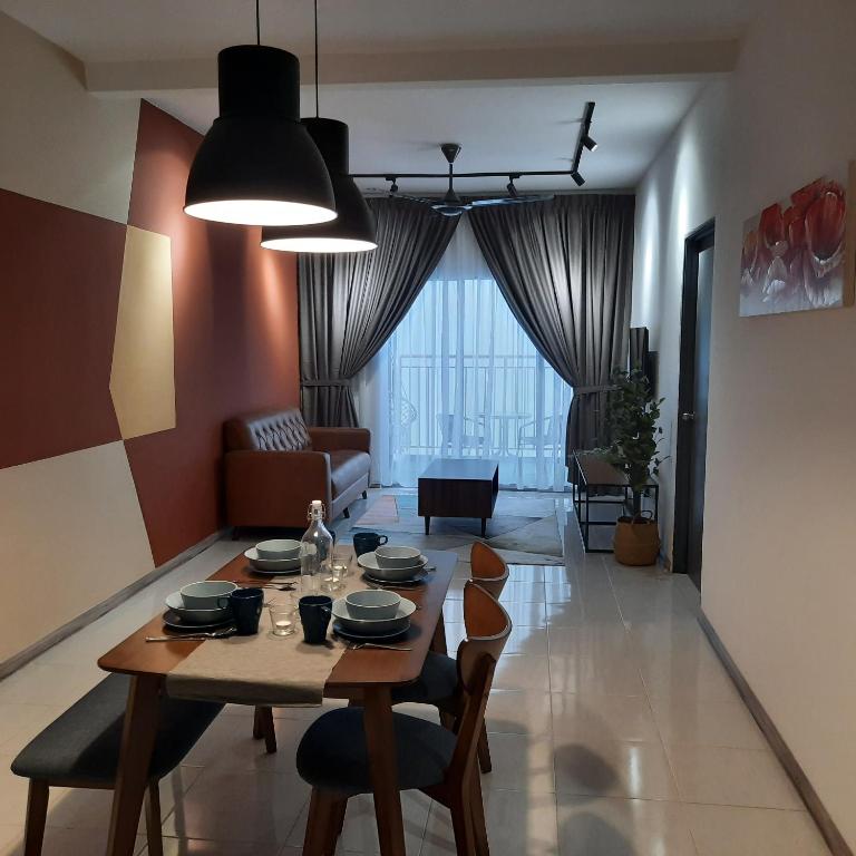 a living room with a table and chairs in a room at V Cozy Homestays in Brinchang