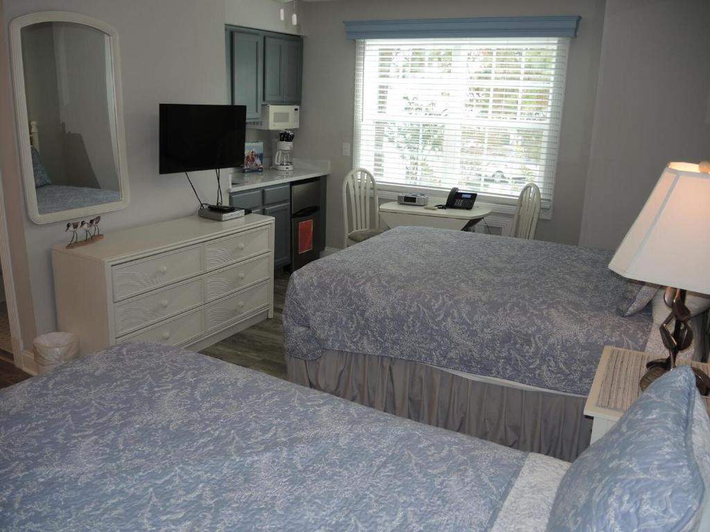 a hotel room with two beds and a television at Studio Style Home 308L features Golf in Calabash