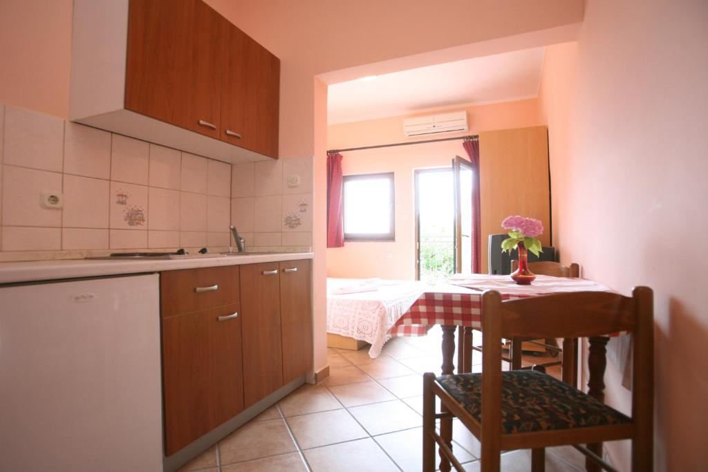 a kitchen with a table and a dining room at Apartments Neda - Poreč South in Poreč