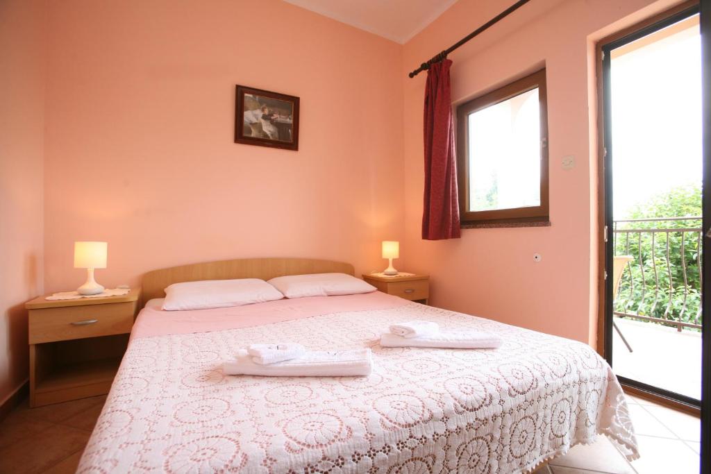 a bedroom with a bed with two towels on it at Apartments Neda - Poreč South in Poreč