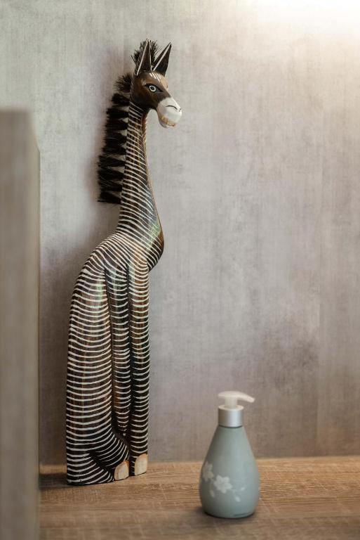 a statue of a giraffe standing next to a vase at Villa Eltins in Bad Bentheim