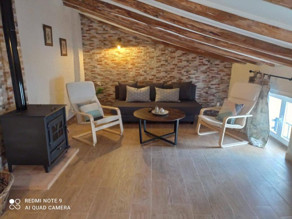 a living room with a couch and a table and chairs at San Francisco II in Siles