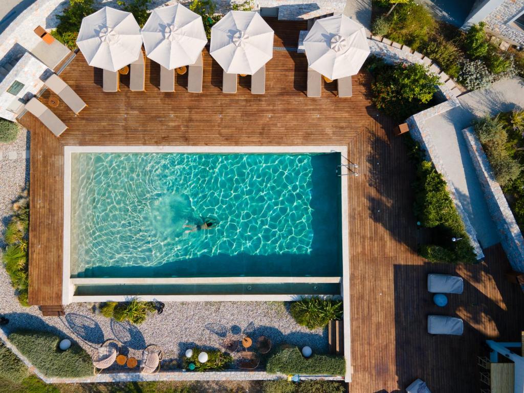 an overhead view of a swimming pool with umbrellas at Elies Residences in Mytilene
