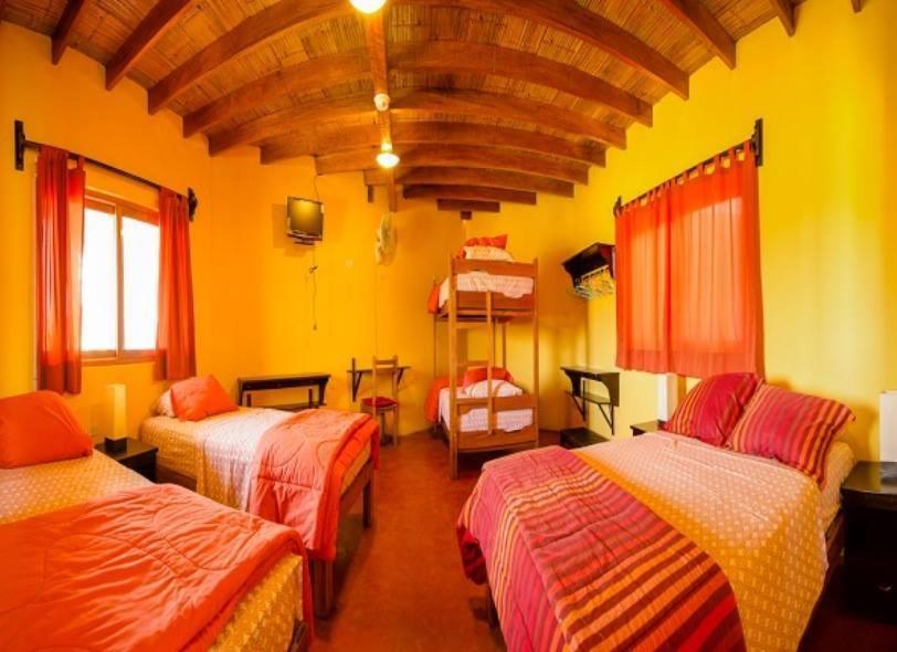 a room with three beds in a room at Mancora y Sol in Máncora