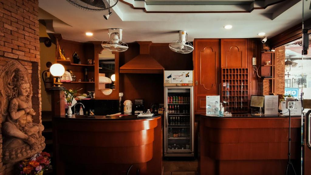 a kitchen with wooden cabinets and a counter and a bar at Max Residence in Pattaya Central