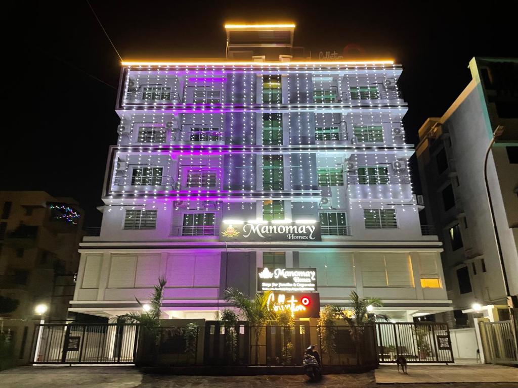 a building with lights on it at night at Manomay Homes in Nagpur