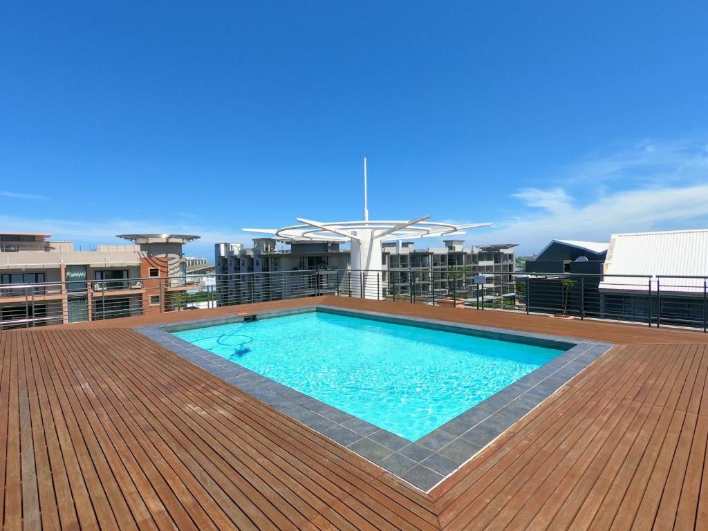 a swimming pool on the roof of a building at Stunning 2 Bed - Rooftop Braai Area - Sunset Views in Durban