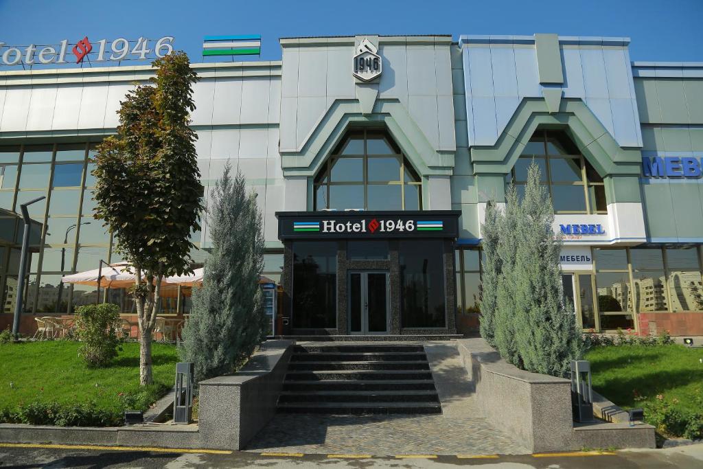 a building with a hotel sign in front of it at Hotel 1946 in Tashkent