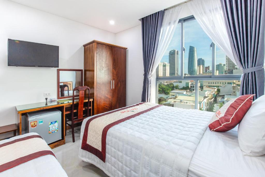 Postel nebo postele na pokoji v ubytování Bao Ngoc Hotel & Apt
