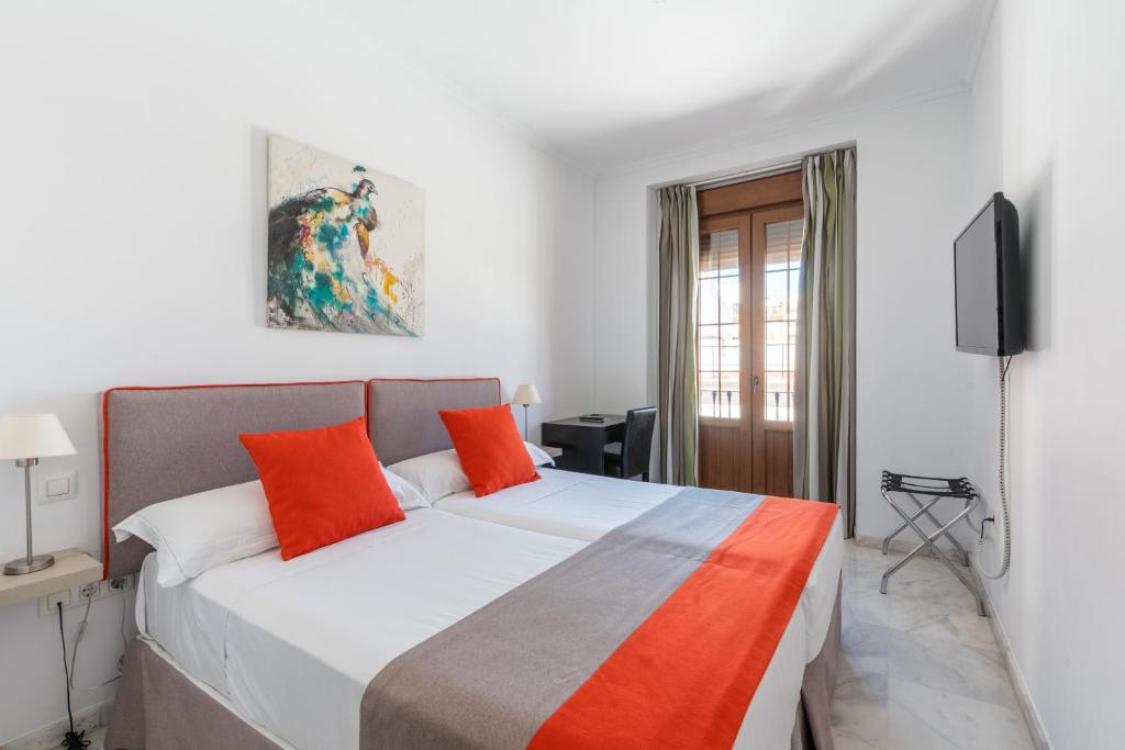 Cama o camas de una habitación en Cool Sevilla Hotel