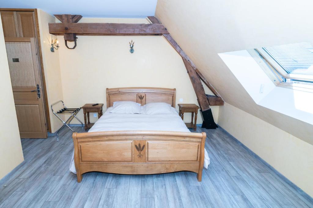 En eller flere senge i et værelse på Ferme d'Auxonnettes