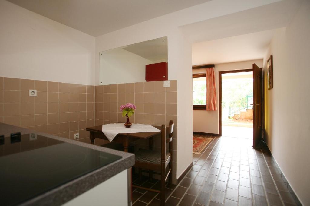 a kitchen with a table and a dining room at Apartments Neda - Poreč South in Poreč