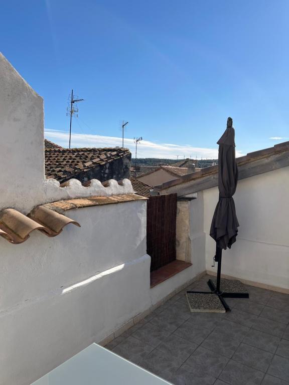 a closed umbrella sitting on the ledge of a building at Appartement loft toit/terrasse in Sigean