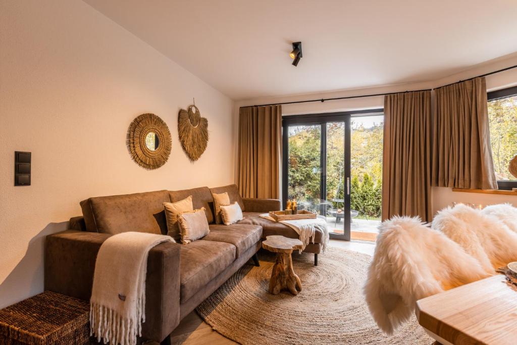 a living room with a couch and a large window at LODGE7 by Woods Lodge in Seefeld in Tirol