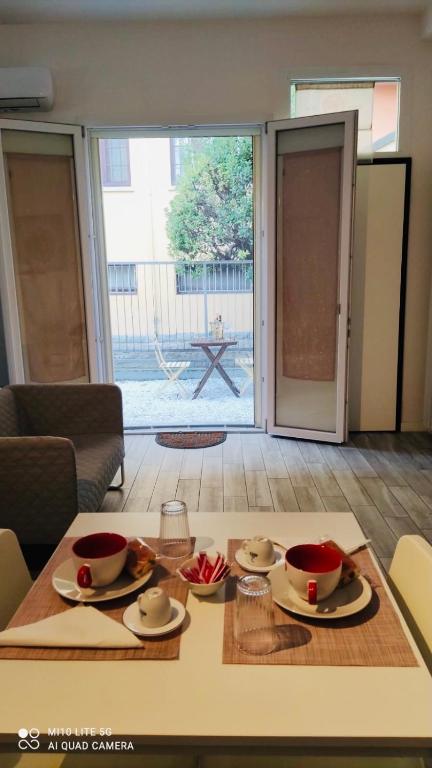 a table with plates and bowls on it in a living room at CASA SAVENA in Bologna