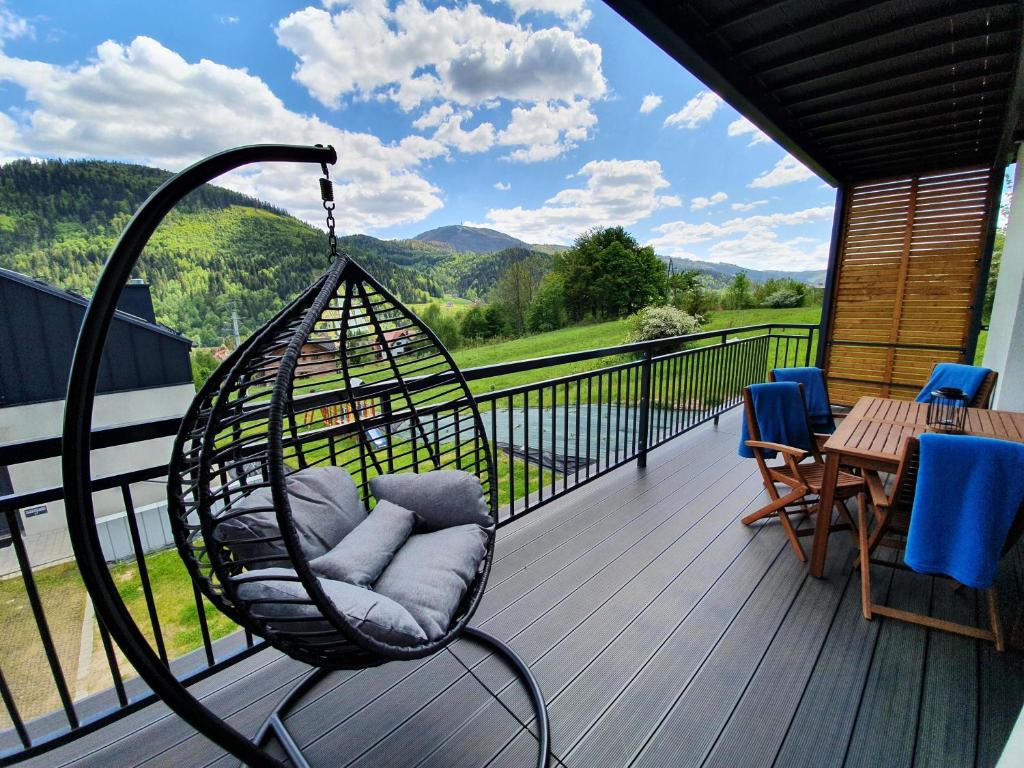 un'altalena su un balcone con vista sulle montagne di RelaxApart - Komfortowy apartament z prywatną sauną a Szczyrk