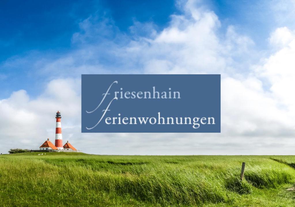 a lighthouse on a grassy hill with the words australian inverswain at Friesenhain Ferienwohnungen in Sankt Peter-Ording