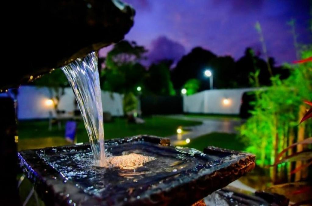 a bird bath with water coming out of it at Slnco Villa in Katunayaka