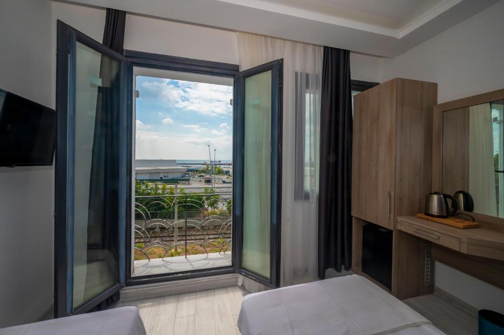A bed or beds in a room at Okda Hotel