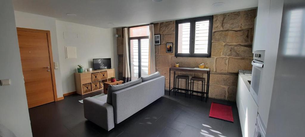 a living room with a couch and a kitchen at Casas da Bríxida. Primeiro in Cangas de Morrazo
